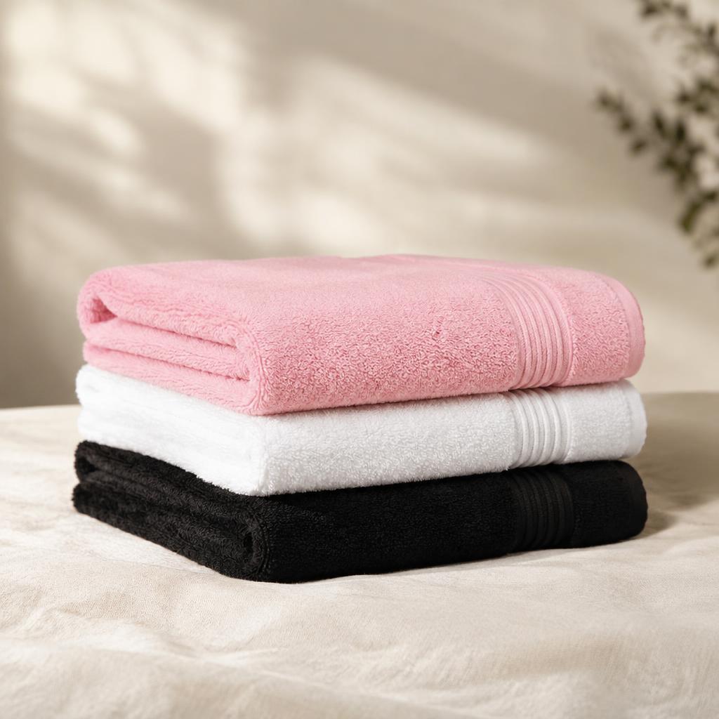 Stack of folded pink, white and black towels